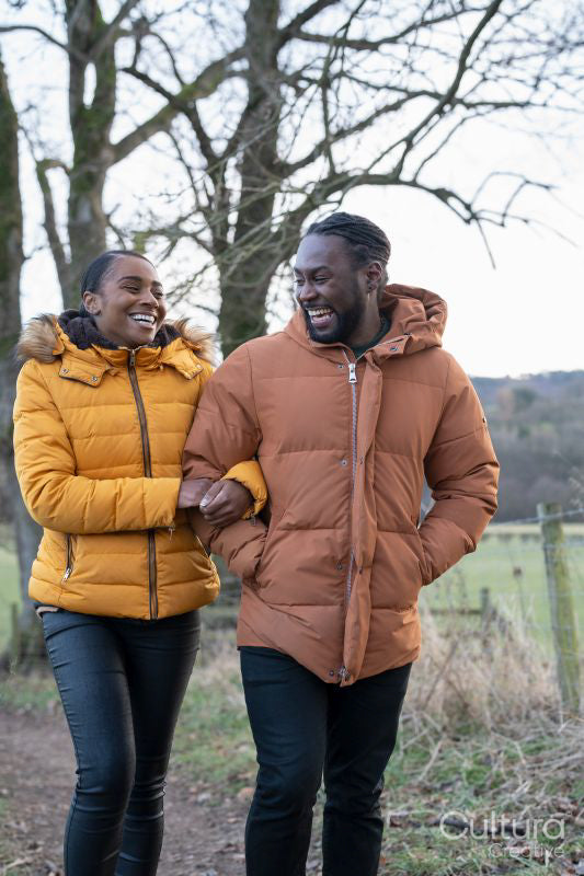 Couple in winter jackets walking in rural setting