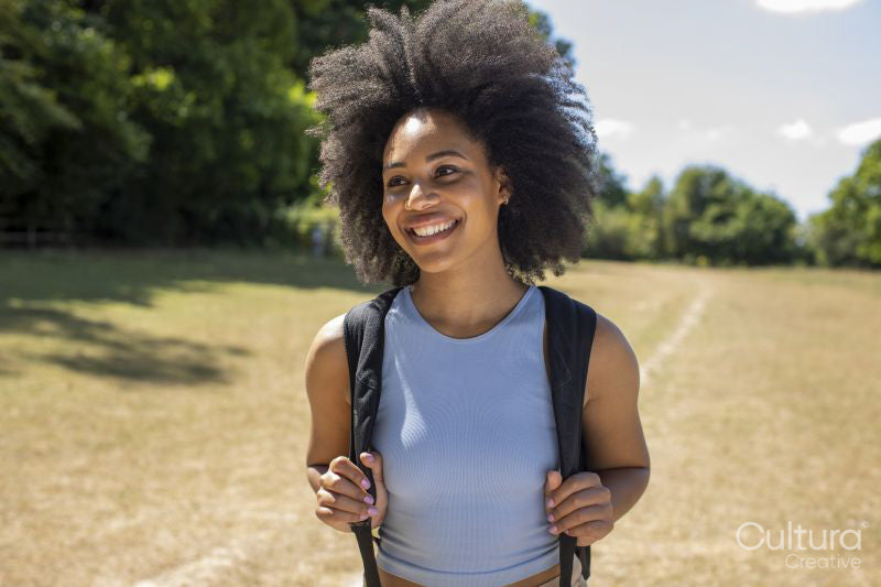 Portrait of young woman hiking in countryside