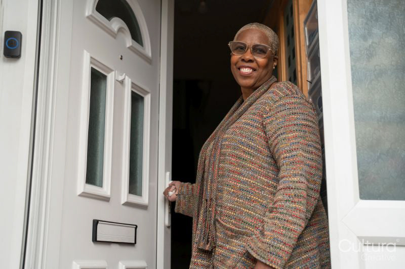 Mature woman standing at front door