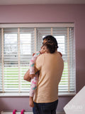 Father carrying sleepy daughter