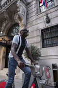 Mature man using city bike on street