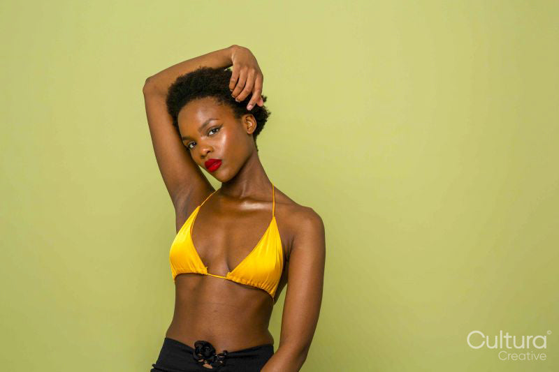 Studio portrait of woman in yellow bikini top