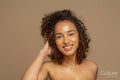Portrait of smiling woman with curly hair