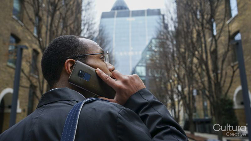 Business man walking and using phone