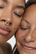 Close-up of two women with eyes closed