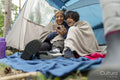 Mother and son using phone in tent