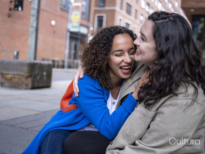 couple embracing and laughing outdoors