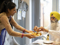 Family in traditional clothing sharing food