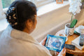 Senior lady sitting with photography at nursing home