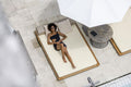 Overhead view of woman relaxing on poolside