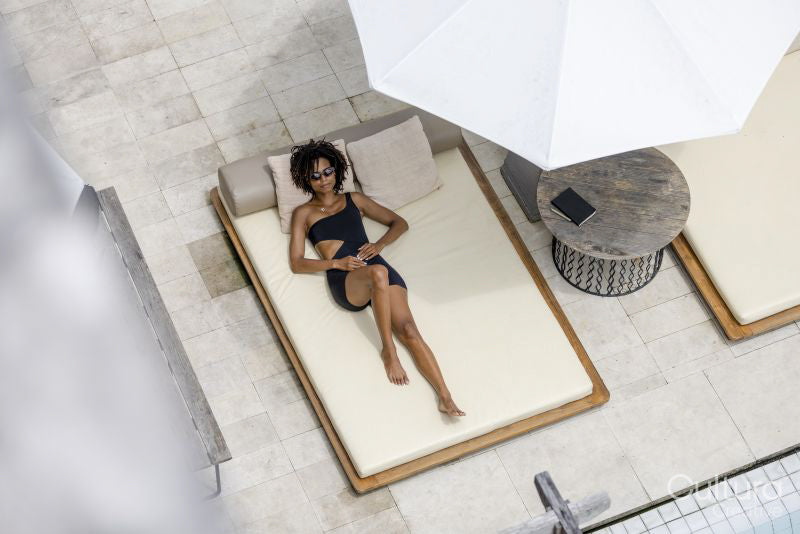 Overhead view of woman relaxing on poolside