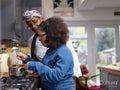 Mother with daughter with Down Syndrome cooking together