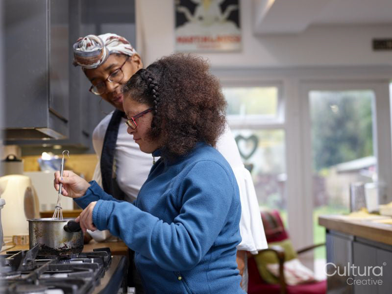 Mother with daughter with Down Syndrome cooking together