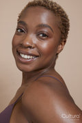 Studio portrait of smiling woman with nose ring