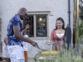 Family with children having barbecue