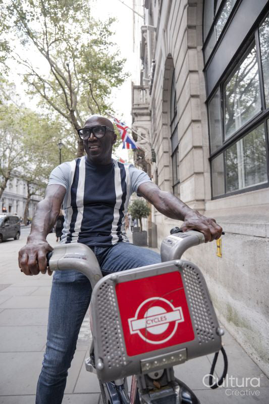 Mature man using city bike on street