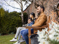 Parents with son sitting on park bench