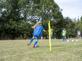 Children dressed in uniforms practicing on soccer field