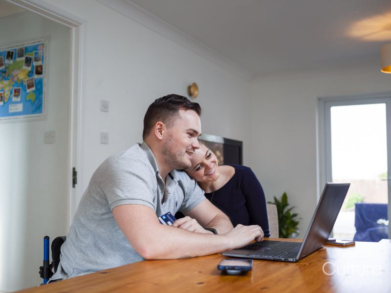 Smiling couple online shopping at home