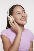Studio portrait of smiling girl with headphones and eyes closed