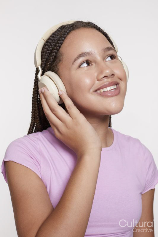 Studio portrait of smiling girl with headphones and eyes closed