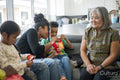 Family gathered in living room, sharing red envelopes