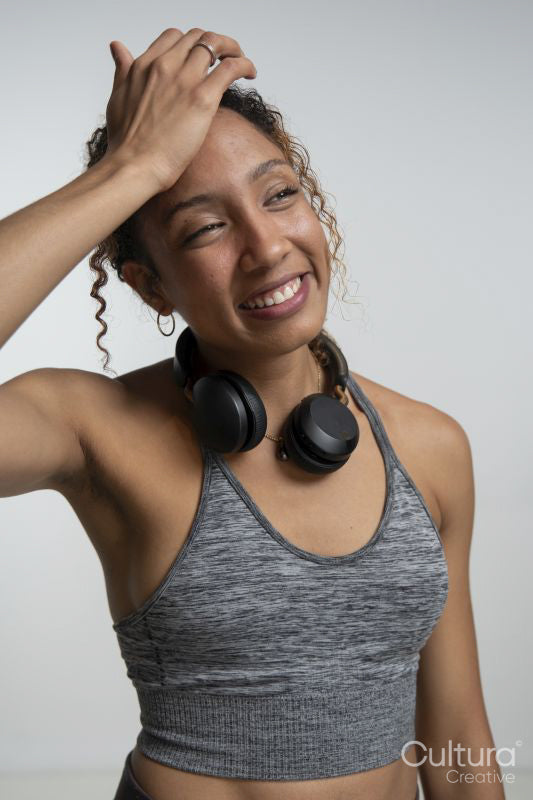 Smiling woman with headphones around neck