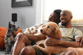 Louisiana, couple with dogs relaxing on sofa