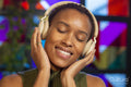 Smiling woman listening to music on headphones