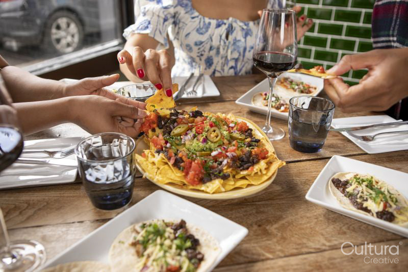 Close-up of friends enjoying Me,ican food at restaurant table