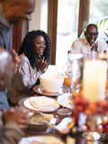 Family sitting at Thanksgiving table and clapping