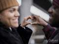 Close-up of couple making heart hand sign
