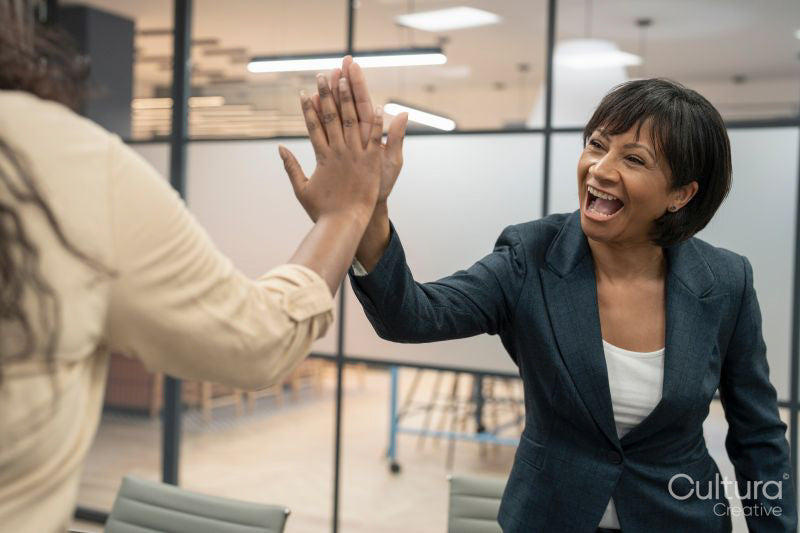 Businesswomen high fiving in office