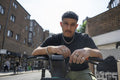 Portrait of man leaning on bikes handlebar