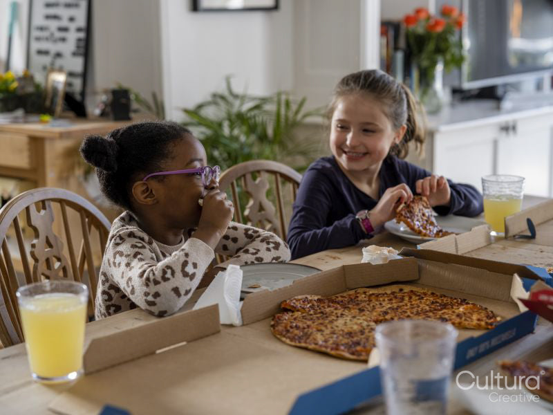 Girls eating pizza at home
