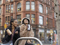 Two young women drinking coffee-to-go