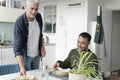 Male couple eating breakfast at home