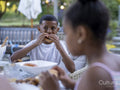 Children eating dinner outdoors