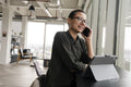 Woman using digital tablet and phone in office
