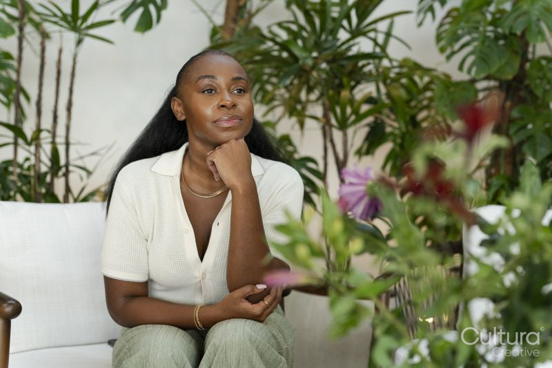 Thoughtful woman sitting in office lounge