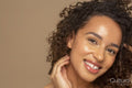 Close-up of smiling woman with curly hair
