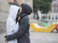 Woman kissing girlfriend on forehead