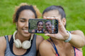 Two women taking selfie with smartphone