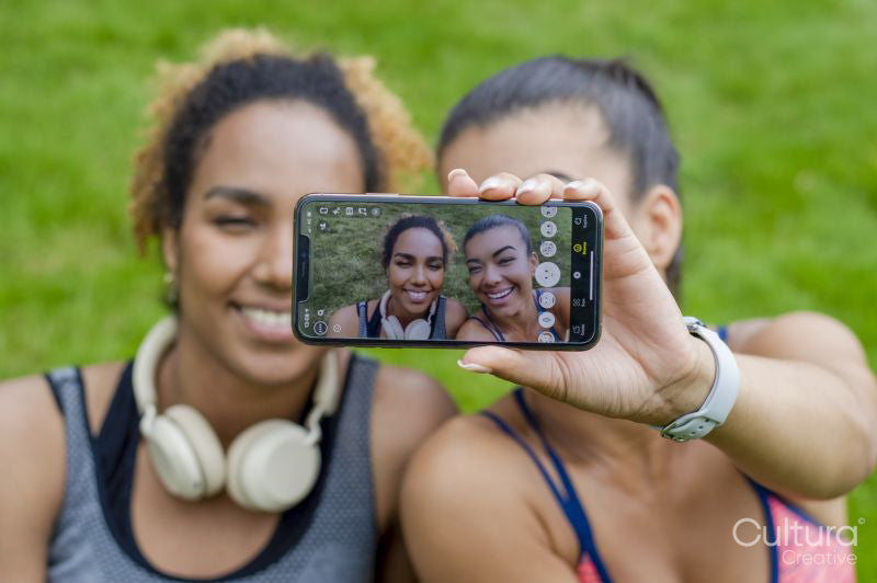 Two women taking selfie with smartphone