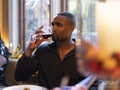 Man drinking red wine at dinner
