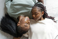 Directly above view of couple sleeping on carpet