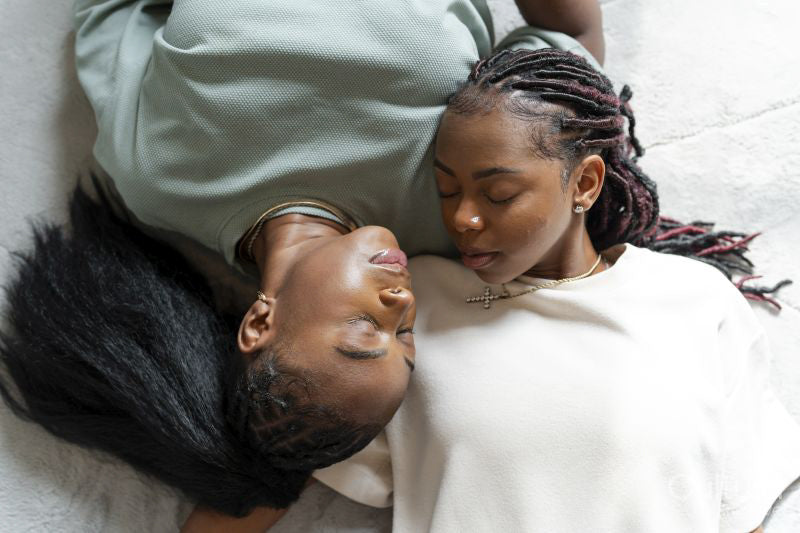 Directly above view of couple sleeping on carpet