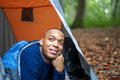Smiling man looking out of open tent