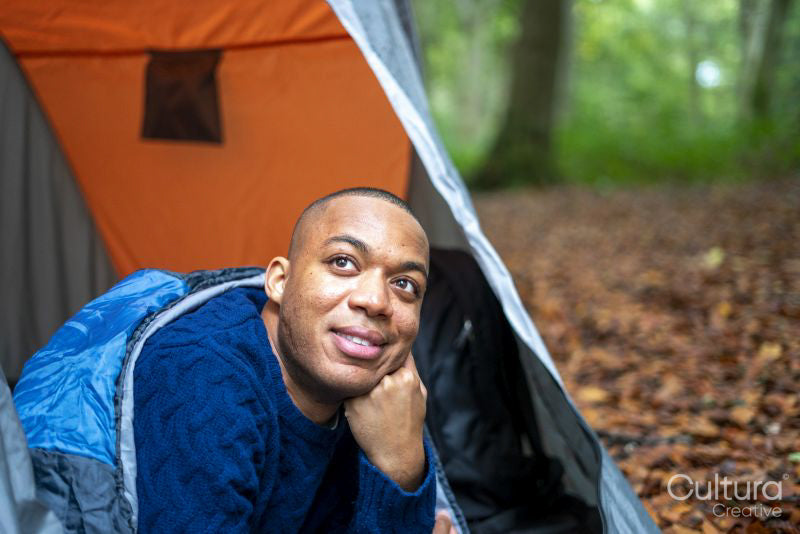 Smiling man looking out of open tent
