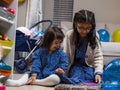 Smiling sisters playing at home